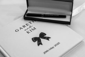 Personalised wedding guest book reading 'Gareth and Kim' with an engraved pen — Mr & Mrs Thomas, 29 May 2025